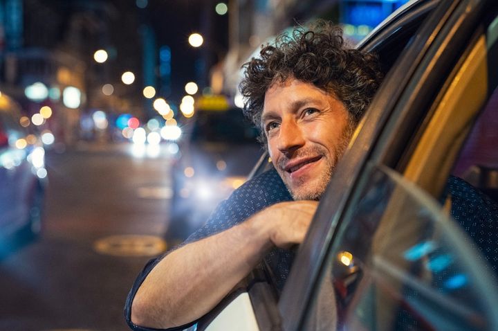 Man looking out of the window of a car